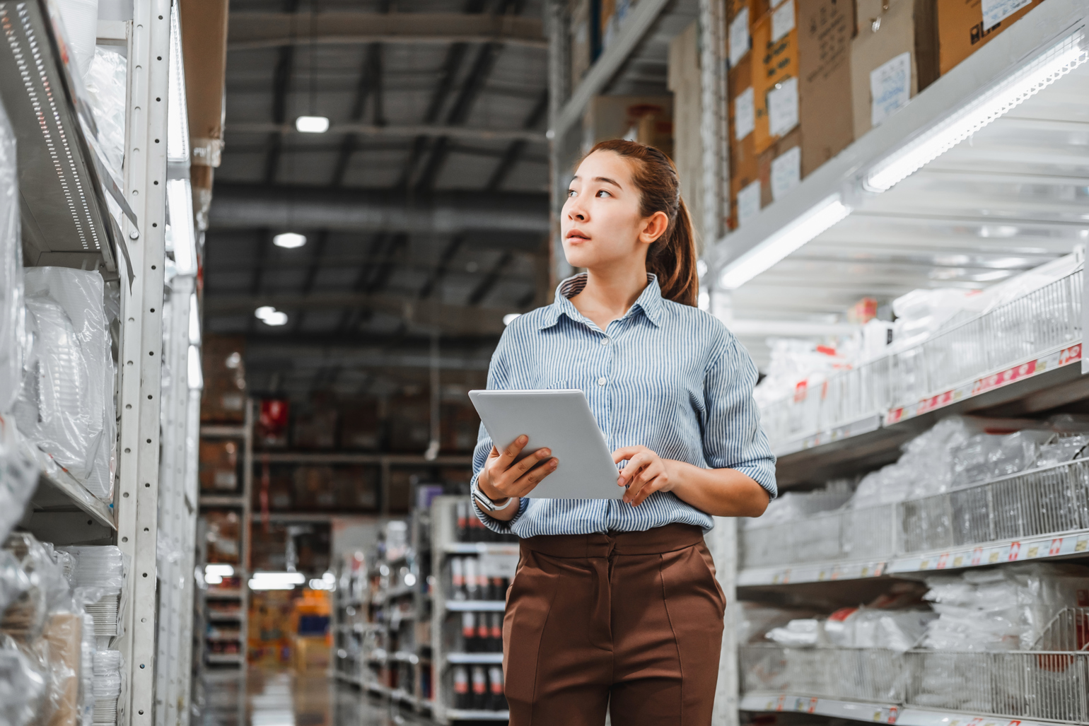 Woman Walking Thru Aisles With Ipad